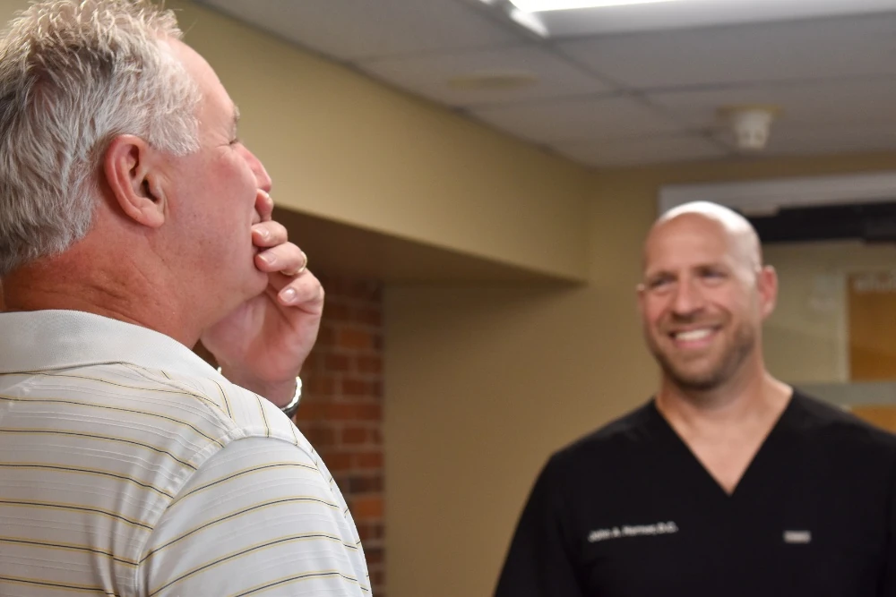 Dr. Herner talking with a new patient at Herner Chiropractic in Nashua