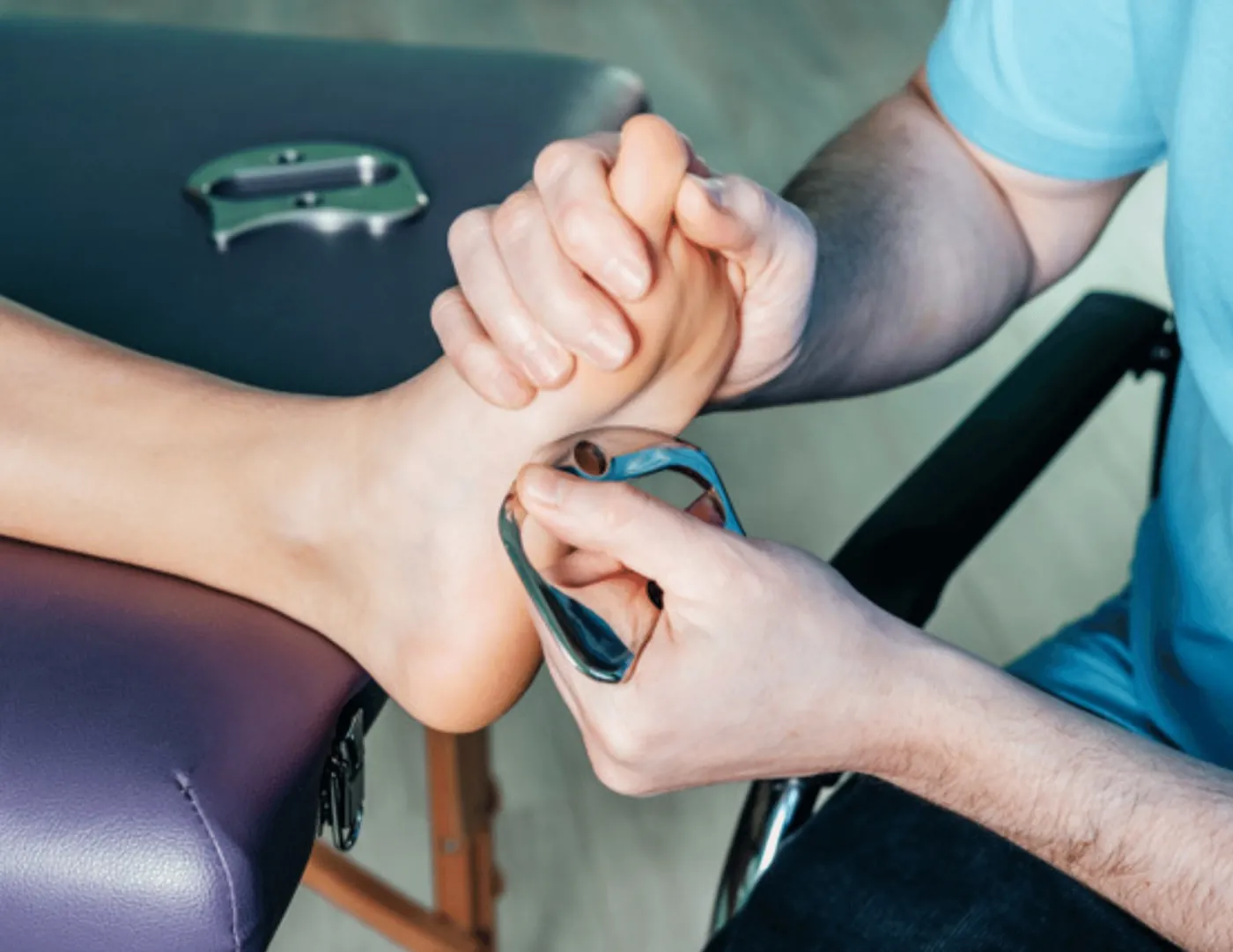 Graston Technique soft-tissue work on the bottom of a foot